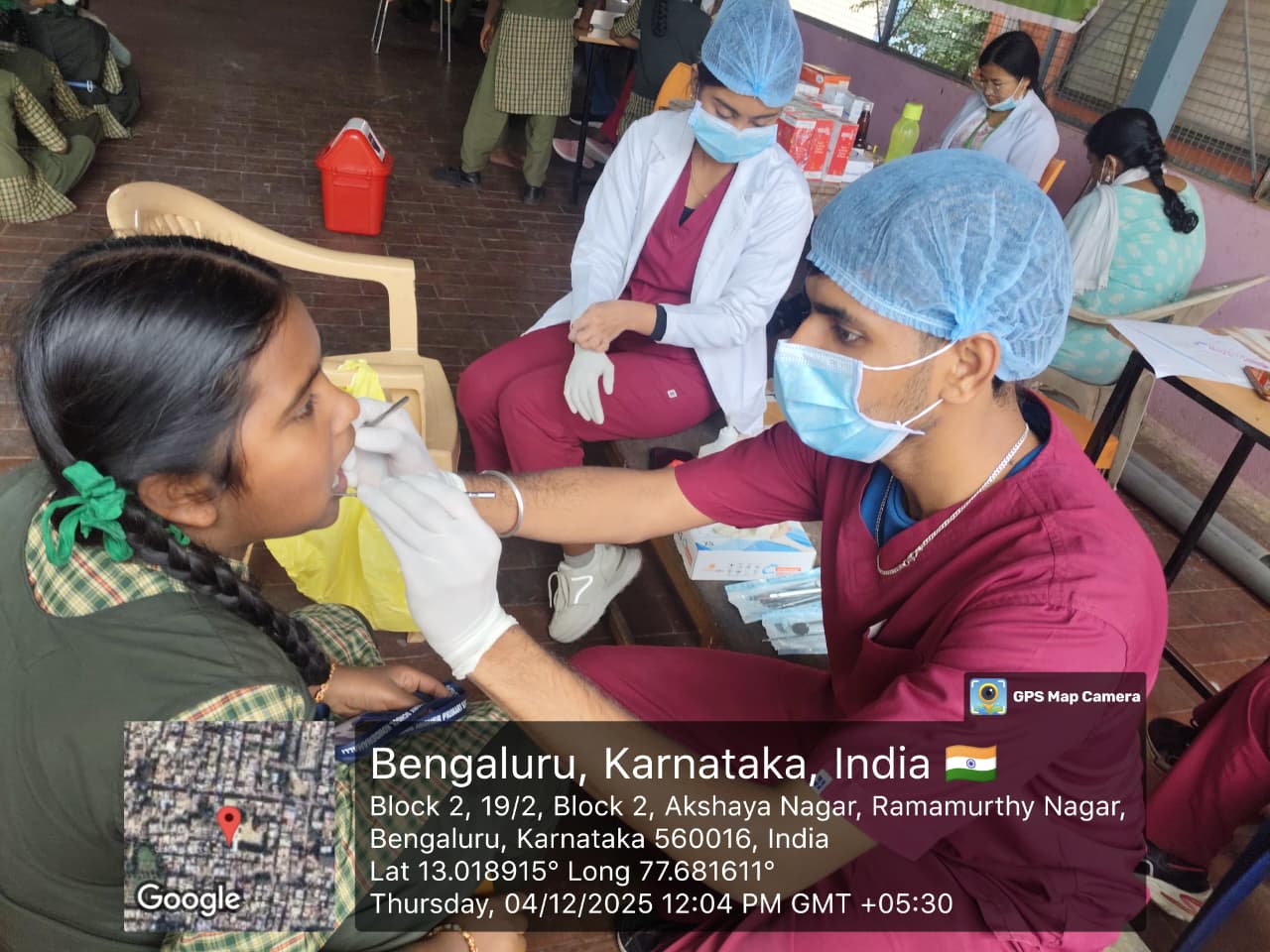 Male dentist examining a student's teeth